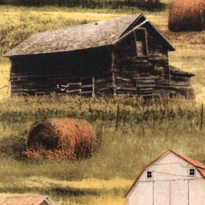 Farm Buildings and Rolls of Hay on Greener Pastures